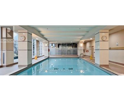 A large indoor swimming pool with a glass bottom.