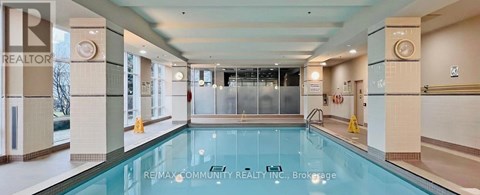 A large indoor swimming pool with a glass bottom.