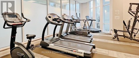 A gym with treadmills, exercise bikes and weights.