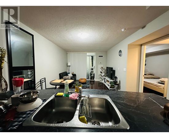 A kitchen with a sink and a mirror.