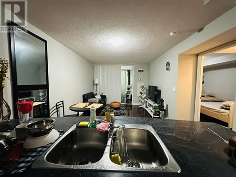 A kitchen with a sink and a mirror.