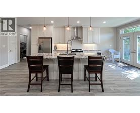 A kitchen with a table and chairs in front of it.