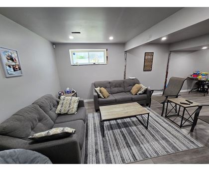 A living room with grey couches and a coffee table.