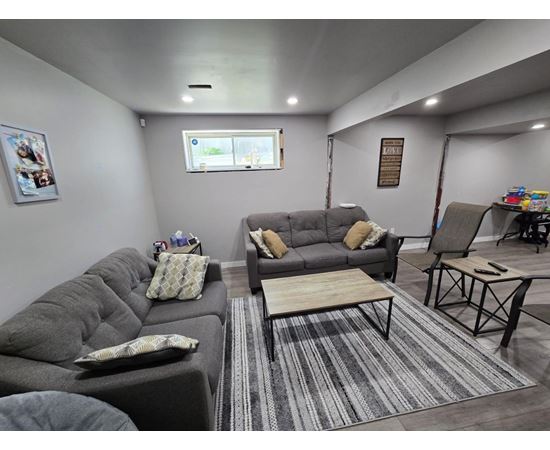 A living room with grey couches and a coffee table.