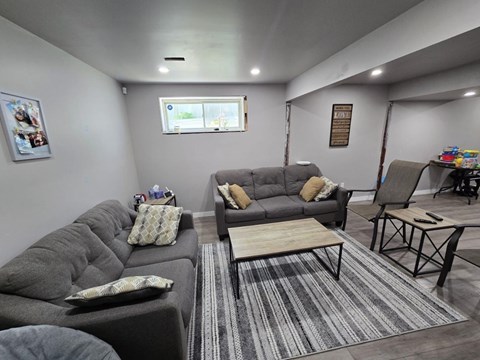 A living room with grey couches and a coffee table.