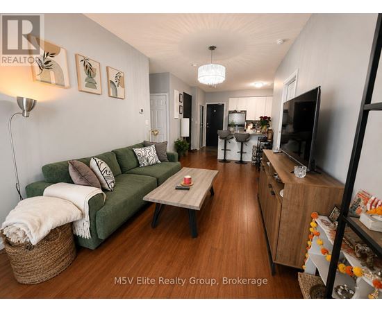 A living room with a green couch and a wooden floor.