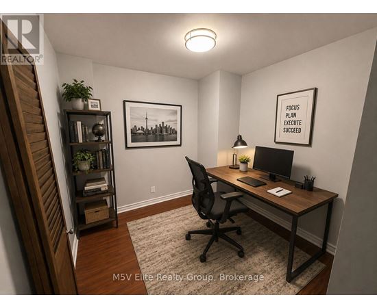 A room with a desk, chair, and a framed picture on the wall.