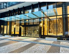 A modern building with a glass entrance and a sign that says "REALTOR".