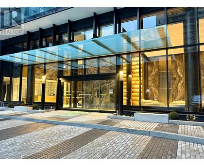 A modern building with a glass entrance and a sign that says "REALTOR".