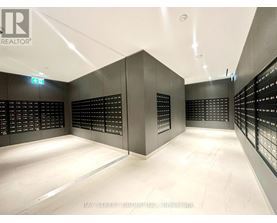 A brokerage office with a white floor and black walls.