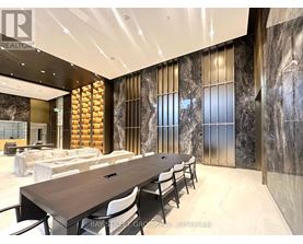 A conference room with a long table and chairs.
