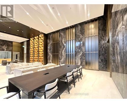 A conference room with a long table and chairs.