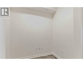 A white room with a Realtor logo on the top left corner.