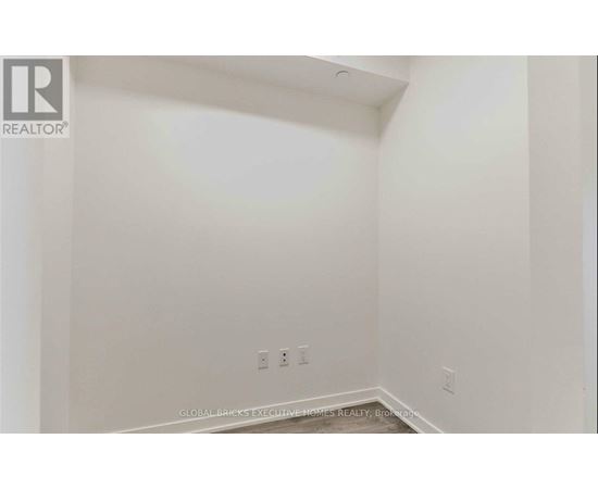 A white room with a Realtor logo on the top left corner.