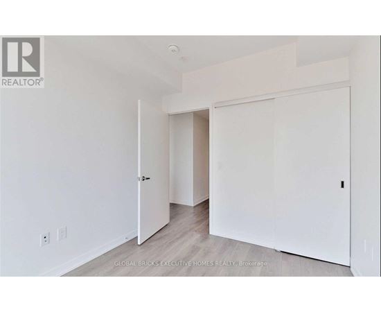 A white room with a door and a window.