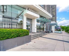 A modern building with a glass facade and a sign that reads "2-ANNODALE" is shown.
