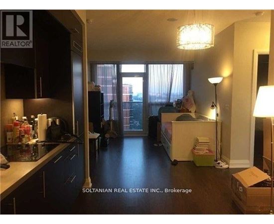 A kitchen with a box on the floor.