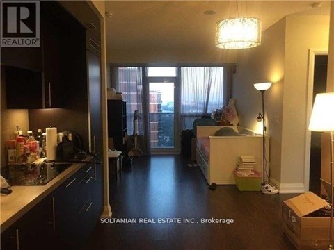 A kitchen with a box on the floor.