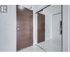 A modern room with a wooden door and a glass door.