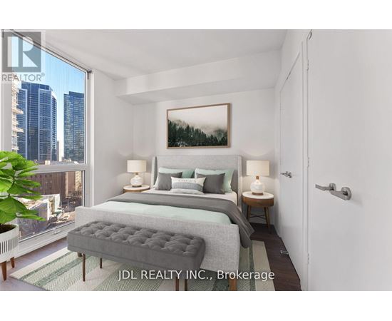 A bedroom with a large bed and a city view through the window.