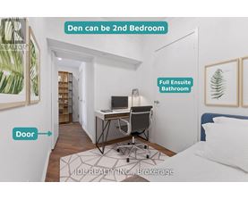 A bedroom with a desk and a full bathroom in the other room.