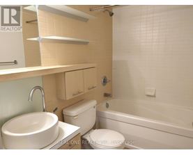 A white sink is on a countertop in a bathroom.