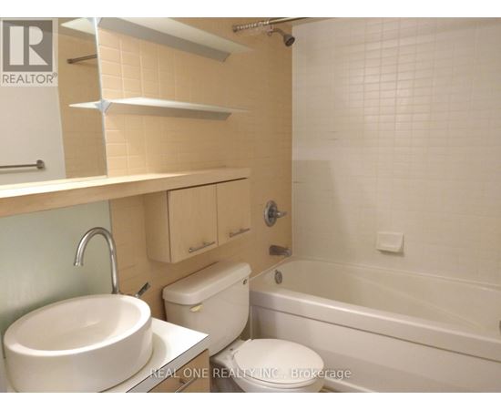 A white sink is on a countertop in a bathroom.