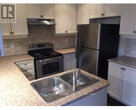 A kitchen with a black refrigerator and stove.