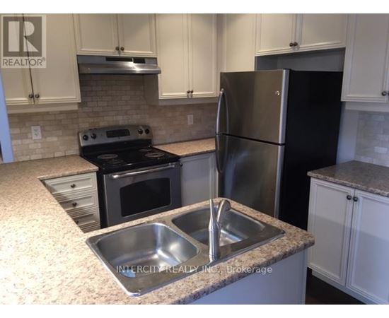 A kitchen with a black refrigerator and stove.