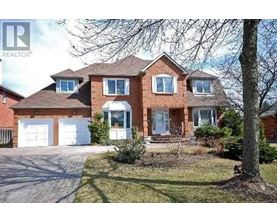 A large brick house with a white garage door.