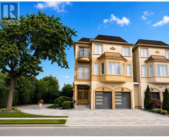 A large, luxurious house with a front yard and a driveway.