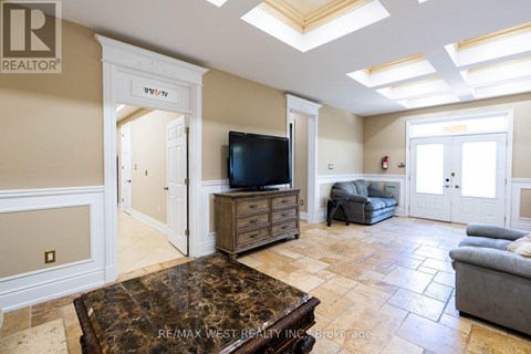 A living room with a brown coffee table and a flat screen TV.