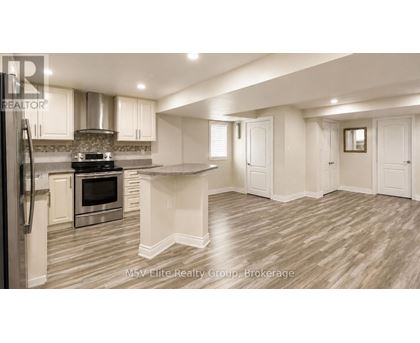 A modern kitchen with a stainless steel refrigerator and a center island.