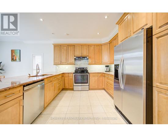 A kitchen with wooden cabinets and stainless steel appliances.