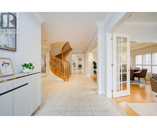 A spacious living room with a wooden spiral staircase.