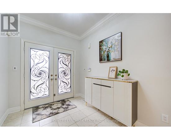 A white interior with a glass door and a framed picture on the wall.