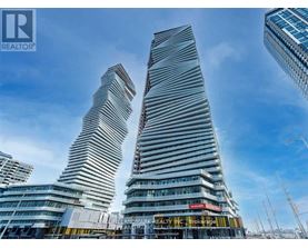 Two tall buildings with curved sides stand next to each other.