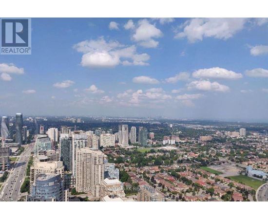 Two tall buildings with curved sides stand next to each other.