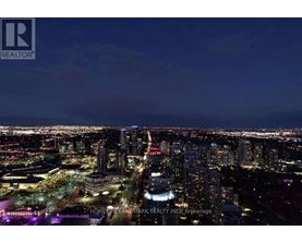 A cityscape at dusk with a sign that reads REALTOR.