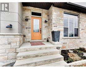 A house with a brown door and a stone wall.