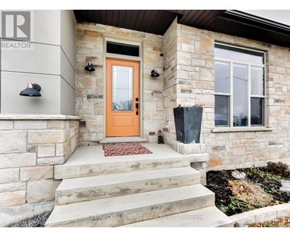 A house with a brown door and a stone wall.