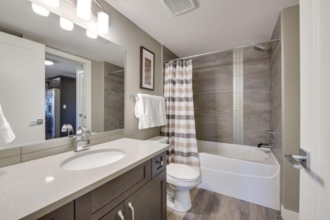 A bathroom with a white sink, toilet, and bathtub.