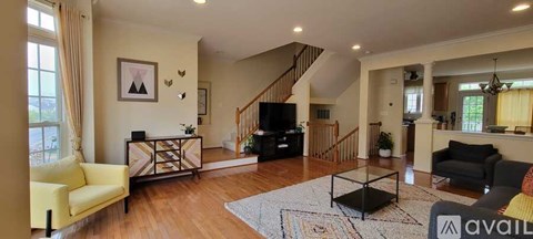 A living room with a yellow couch and a coffee table.