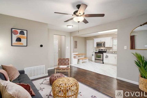 A living room with a ceiling fan and a couch.