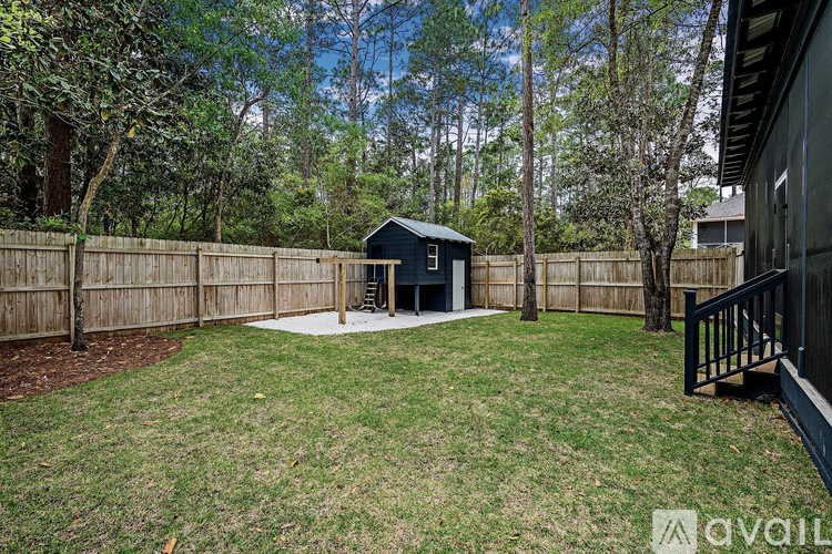 A backyard with a shed and a fence.