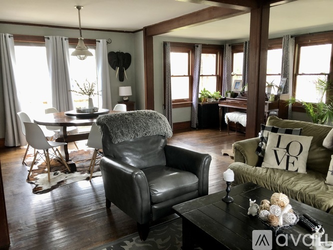 A living room with a black leather chair and a grey armchair.