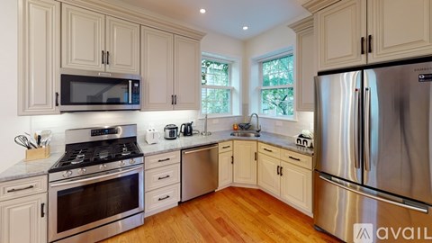 A kitchen with wooden cabinets and stainless steel appliances.