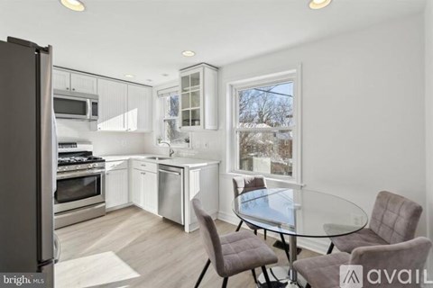 A modern kitchen with a glass table and chairs.
