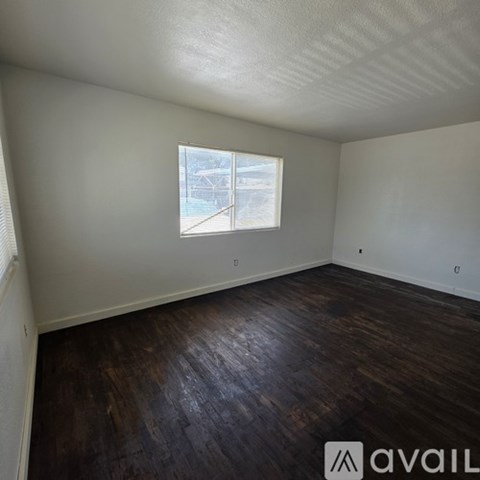 A room with wooden floors and a window.