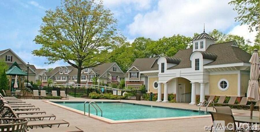 A large house with a pool in front of it.